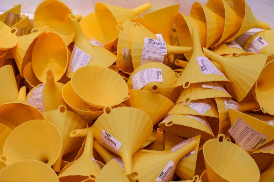 Close-up of a pile of yellow plastic funnels for sale in an Istanbul market.