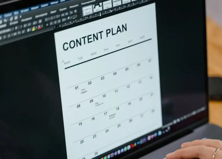 Close-up of hands typing on a laptop displaying a content plan document, ideal for business or marketing content.