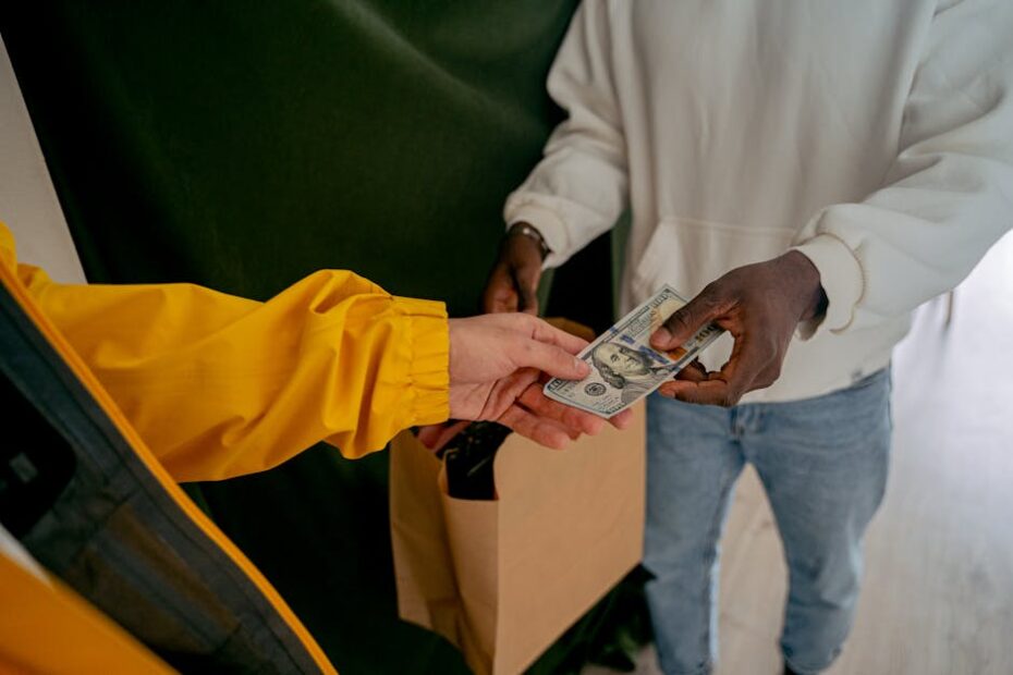 A close-up of a cash transaction between two adults, highlighting financial exchange.